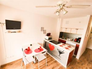 a small kitchen with a table and chairs in a room at Appartement cosy Le Phoebus in Canet-en-Roussillon
