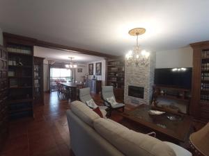 a living room with a couch and a fireplace at Casa Rural Vista Castillo in Almonacid de Toledo