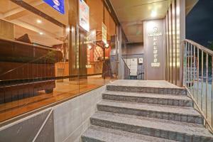 a group of stairs in front of a building at Super Townhouse Edasserys Sea Pearl in Cochin