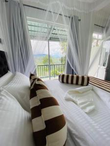 Postel nebo postele na pokoji v ubytování Ella Nimal Nest Inn + 37 fotografií