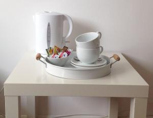 a table with a tray with a cup and a knife at Gästezimmer Kippenhausen in Immenstaad am Bodensee