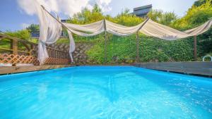 a large swimming pool with a canopy over it at Gapyeong Bonita Pension in Gapyeong
