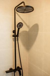 a shower with a shower head in a bathroom at Serō Boutique Hotel in Cù Lao Thu