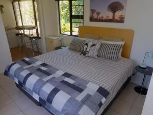una camera da letto con un letto con una coperta blu e bianca di Fisherhaven Guest House a Hermanus