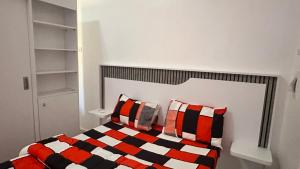 a bedroom with a bed with two pillows at Mini Studio de Luxe in Thiès