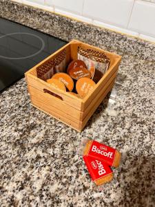 a wooden crate of oranges on a counter with a bag of biscuits at InHome Central Studio in Montilla +17 photos