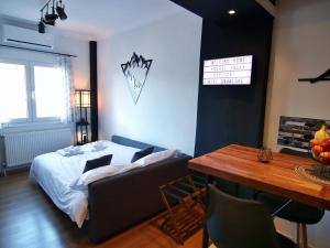 a bedroom with a bed and a table and a table sidx sidx sidx at Spitaki Kastoria Apartment in Kastoria