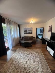 a living room with a couch and a table at Wienerwald Apartments in Baden