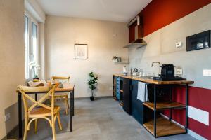 a kitchen with a table and a dining room at Residence La Corte - Bilocale 4 in Novara