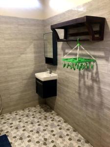 a bathroom with a sink and a mirror at Mountain View House Kampot in Kampot