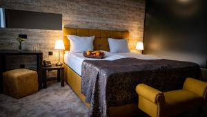 a bedroom with a bed with a bowl of fruit on it at Riverside Boutique Hotel in Bansko +34 photos