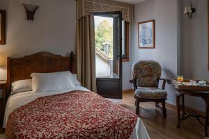 Postel nebo postele na pokoji v ubytování Hotel Rústico Fonteverde