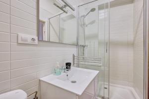 a white bathroom with a sink and a shower at Santo Tomás D in Haro