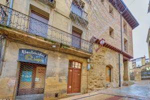 a building with a sign on the side of it at Santo Tomás D in Haro