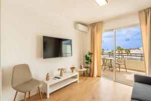a living room with a tv and a balcony at Luxury Studio 1 ocean view wifi free in Adeje
