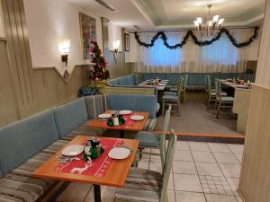 a restaurant with tables and chairs and a christmas tree at Hotel-Bad Goisern in Bad Goisern