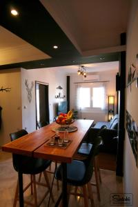 a dining room with a wooden table and chairs at Spitaki Kastoria Apartment in Kastoria