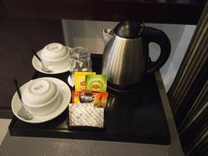 a table with a coffee pot and food on it at Asfar Hotel Apartments أسفار للشقق الفندقية in Muscat +14 photos