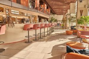 a restaurant with a row of chairs and tables at Room Mate Aitana, Amsterdam in Amsterdam