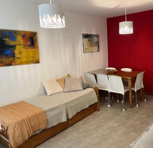 a bedroom with a bed and a table with chairs at Apartamento San Martín de los Andes in San Martín de los Andes