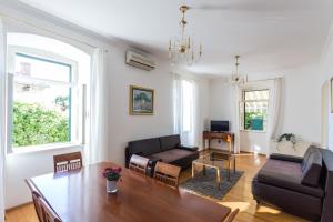 a living room with a table and a couch at Apartment Thalassicus A27 in Dubrovnik