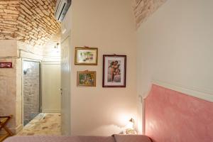 Ένα ή περισσότερα κρεβάτια σε δωμάτιο στο A Casa di Marilù by Rentbeat