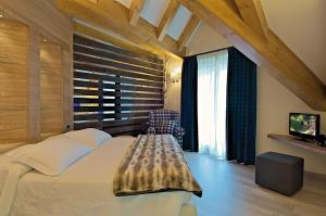 Posteľ alebo postele v izbe v ubytovaní Il Piccolo Dolomiti Resort