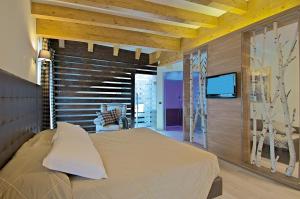Posteľ alebo postele v izbe v ubytovaní Il Piccolo Dolomiti Resort + 37 fotografií