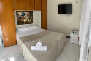 a bedroom with a bed with two towels on it at Hotel Shalom in Juazeiro do Norte