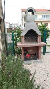 a brick oven with a bell on top of it at Rasin Mobile Homes in Pakoštane
