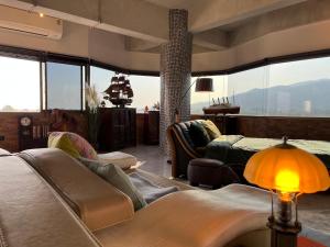 a living room with a couch and a table at Luxury Apartment in Nimman, 5 mins to Maya in Chiang Mai