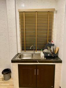 a kitchen with a sink and a wooden window at Hm House Patong in Patong Beach +40 photos