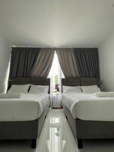 Letto o letti in una camera di TDOZE Hotel