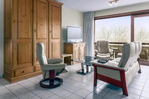 a living room with two chairs and a tv at Mathieu 1 - A2 G in Oostduinkerke