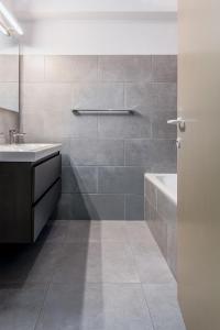 a bathroom with a sink and a bath tub at Mathieu 1 - A2 G in Oostduinkerke