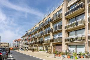 an apartment building with balconies on a street at Mathieu 1 - A2 G in Oostduinkerke