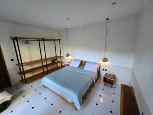 a bedroom with a bed and a tiled floor at Villa crush of heart with swimming pool in Umalas