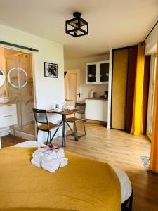 a room with a bed and a table and chairs at Le Golden-Terrasse & Parking in Rennes