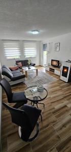 a living room with a couch and a table at Apartman Deny in Sanski most