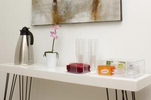 a white shelf with a flower in a vase on it at Hab Urban Hostel in Segovia