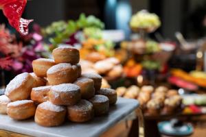 a pile of sugar covered donuts on a table at Ca' Bonfadini Historic Experience in Venice
