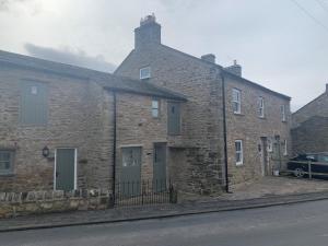 a brick building with a car parked in front of it at White Lea in Grinton