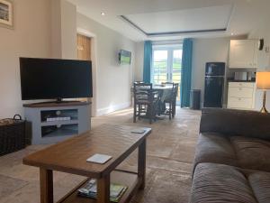a living room with a couch and a table at White Lea in Grinton