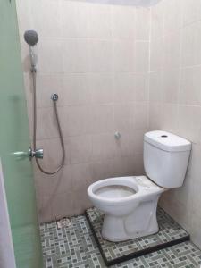 a bathroom with a toilet in a shower stall at Pandya Bromo Villa in Pasuruan +3 photos