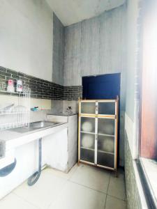 a kitchen with a sink and a shelf in it at Pandya Bromo Villa in Pasuruan