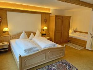 a bedroom with a large bed with white pillows at Alkira in Sankt Anton am Arlberg
