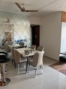 a dining room with a table and chairs at 3 BHK exclusive suite in Nashik