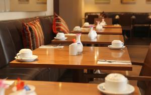 a row of tables with white vases on them at Gresham Belson Hotel Brussels in Brussels