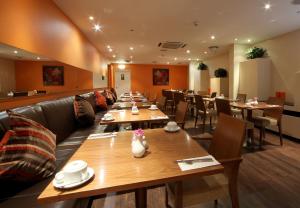 a restaurant with long tables and chairs in a room at Gresham Belson Hotel Brussels in Brussels