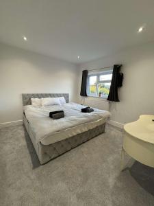 a bedroom with a large bed and a window at A home away from home in Ash